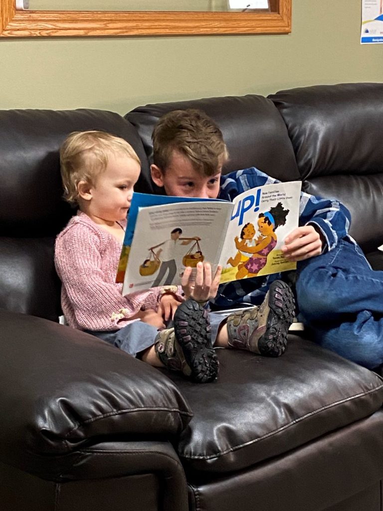 Brother reading to sister